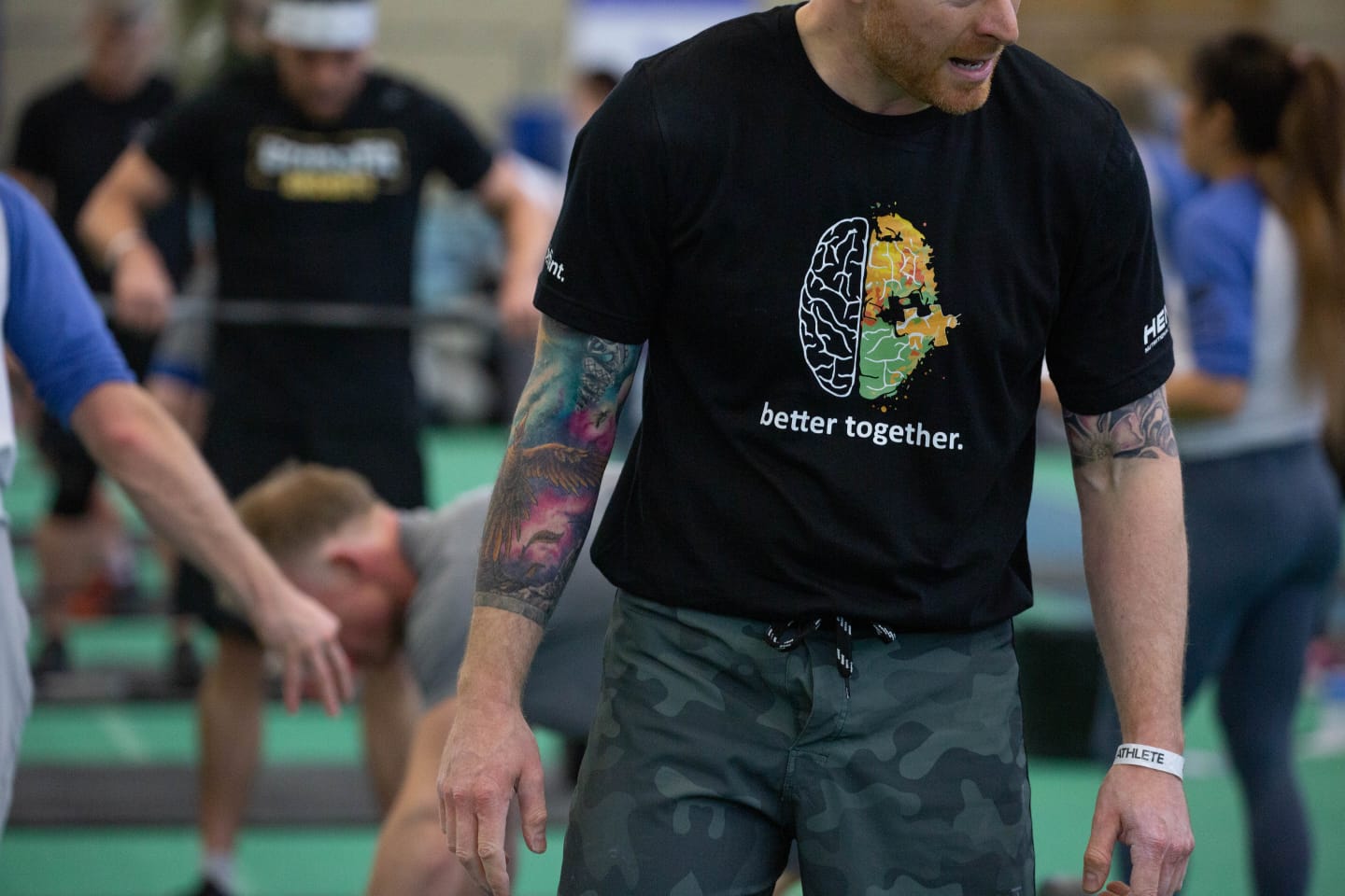 Man Wearing Black T Shirt & Camo Shorts